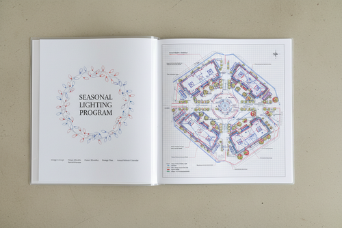 Seasonal Lighting Program binder open to the installation map page showing a commercial plaza with every lighting element labeled