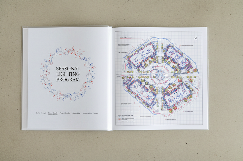 Seasonal Lighting Program binder open to the installation map page showing a commercial plaza with every lighting element labeled